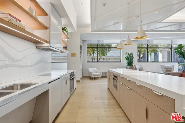 a large white kitchen with a large window