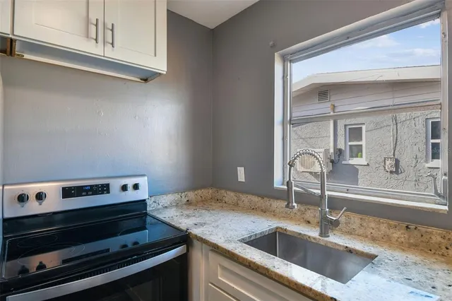 a view of empty room with window and ceiling fan