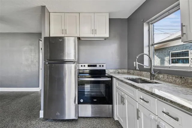 an empty room with a window and a ceiling fan