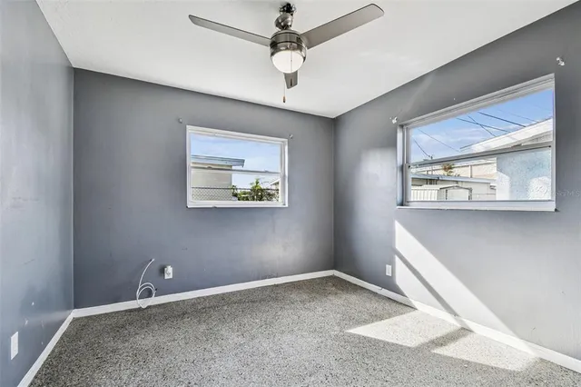 a view of an empty room with a ceiling fan