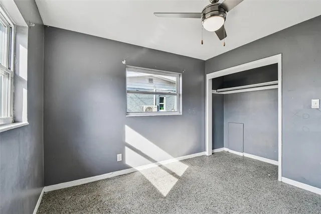 a view of pool with lawn chairs and iron fence