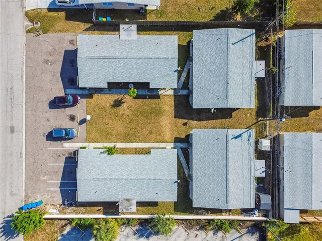 an aerial view of residential houses with outdoor space