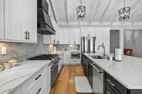 a living room with lots of furniture and kitchen view