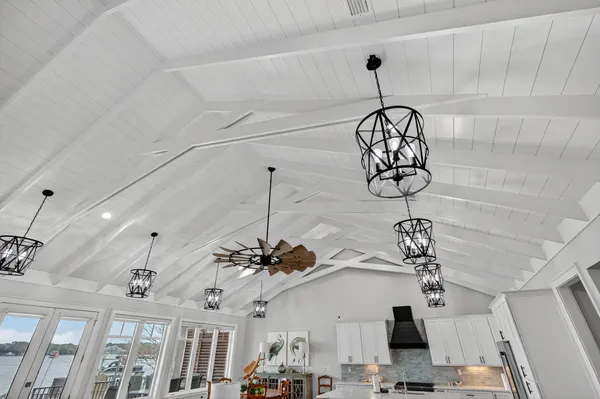 a bathroom with a granite countertop sink a mirror and shower