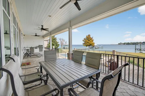 an aerial view of a house with outdoor space and lake view
