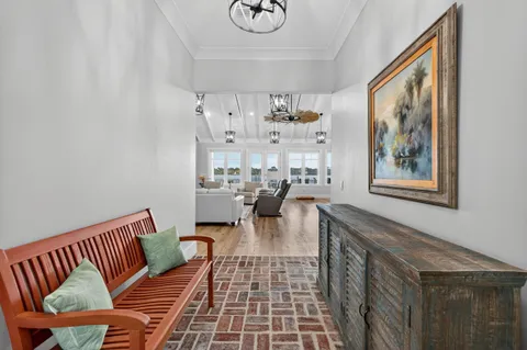 a kitchen with stainless steel appliances kitchen island granite countertop a table chairs stove and cabinets