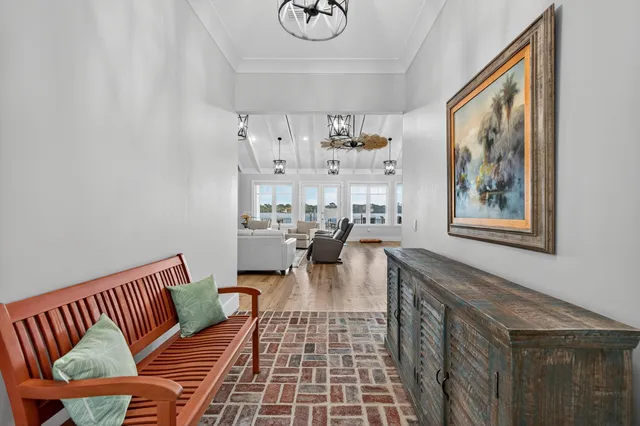 a kitchen with stainless steel appliances kitchen island granite countertop a table chairs stove and cabinets