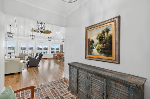 a kitchen with a counter space a sink and living room view