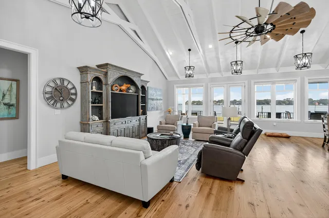 a kitchen with a table chairs and wooden floor