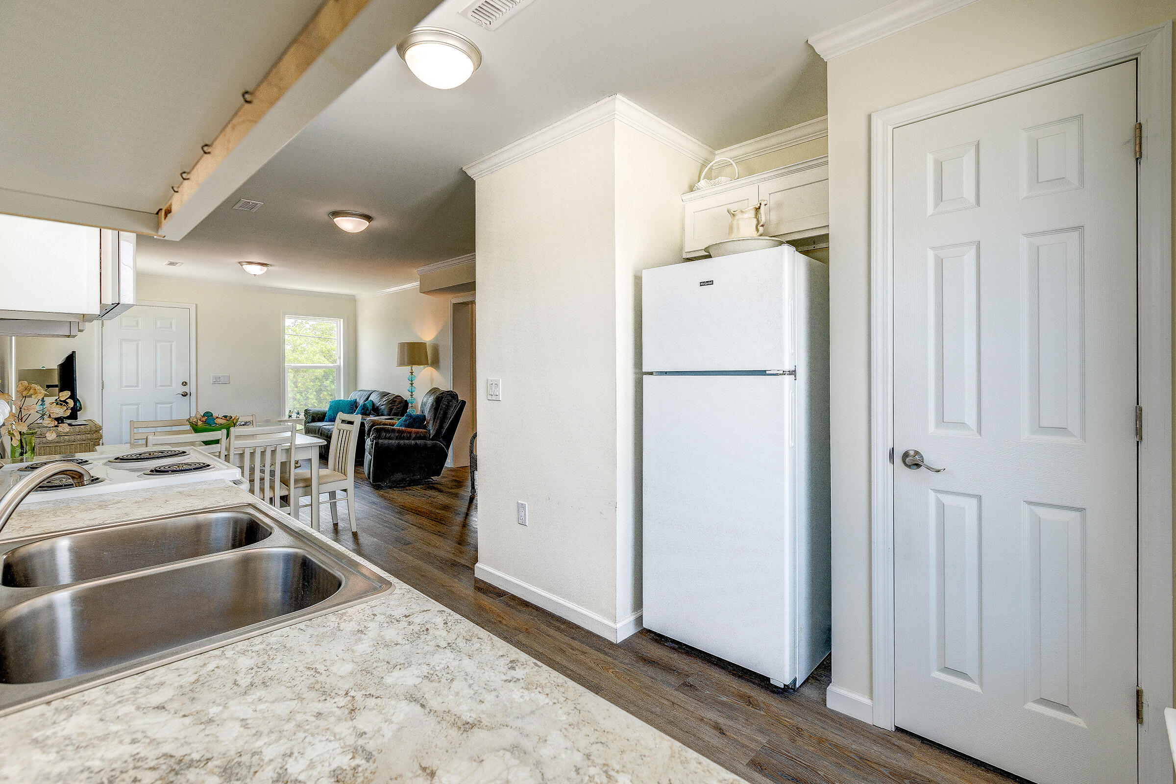 55 Boca Chica Road, Unit 27 Key West, FL 33040 - Photo 11 of 20 a kitchen with a refrigerator sink and white cabinets