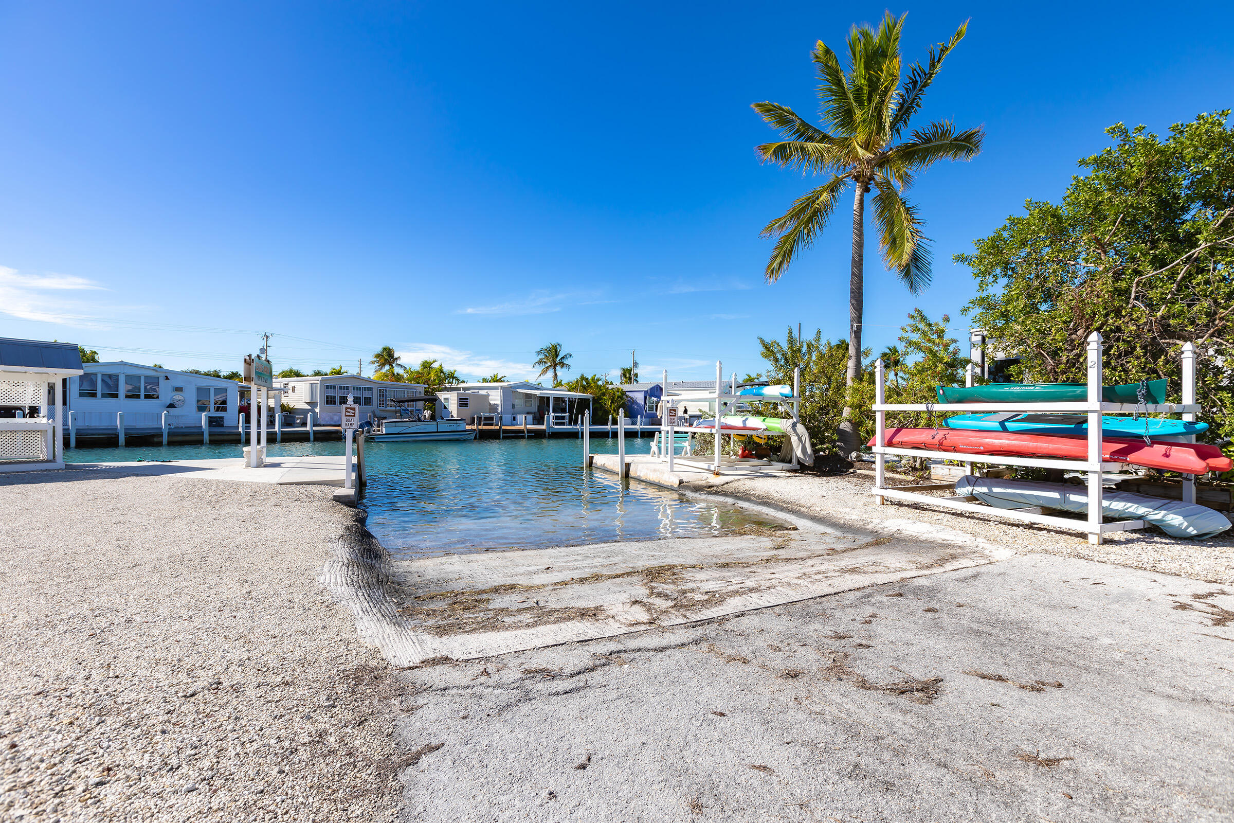 55 Boca Chica Road, Unit 27 Key West, FL 33040 - Photo 18 of 20 a view of a swimming pool with a table and chairs