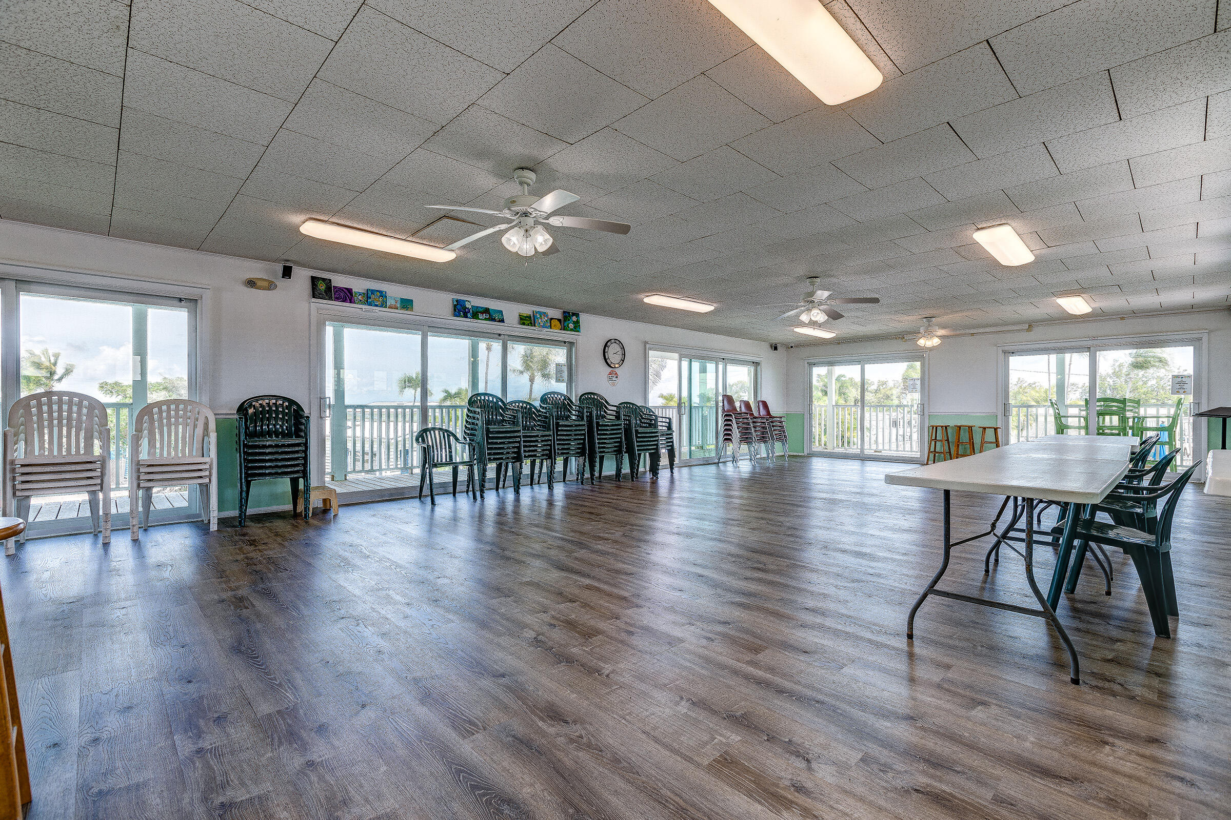 55 Boca Chica Road, Unit 27 Key West, FL 33040 - Photo 20 of 20 a view of a dining room with furniture wooden floor and chandelier
