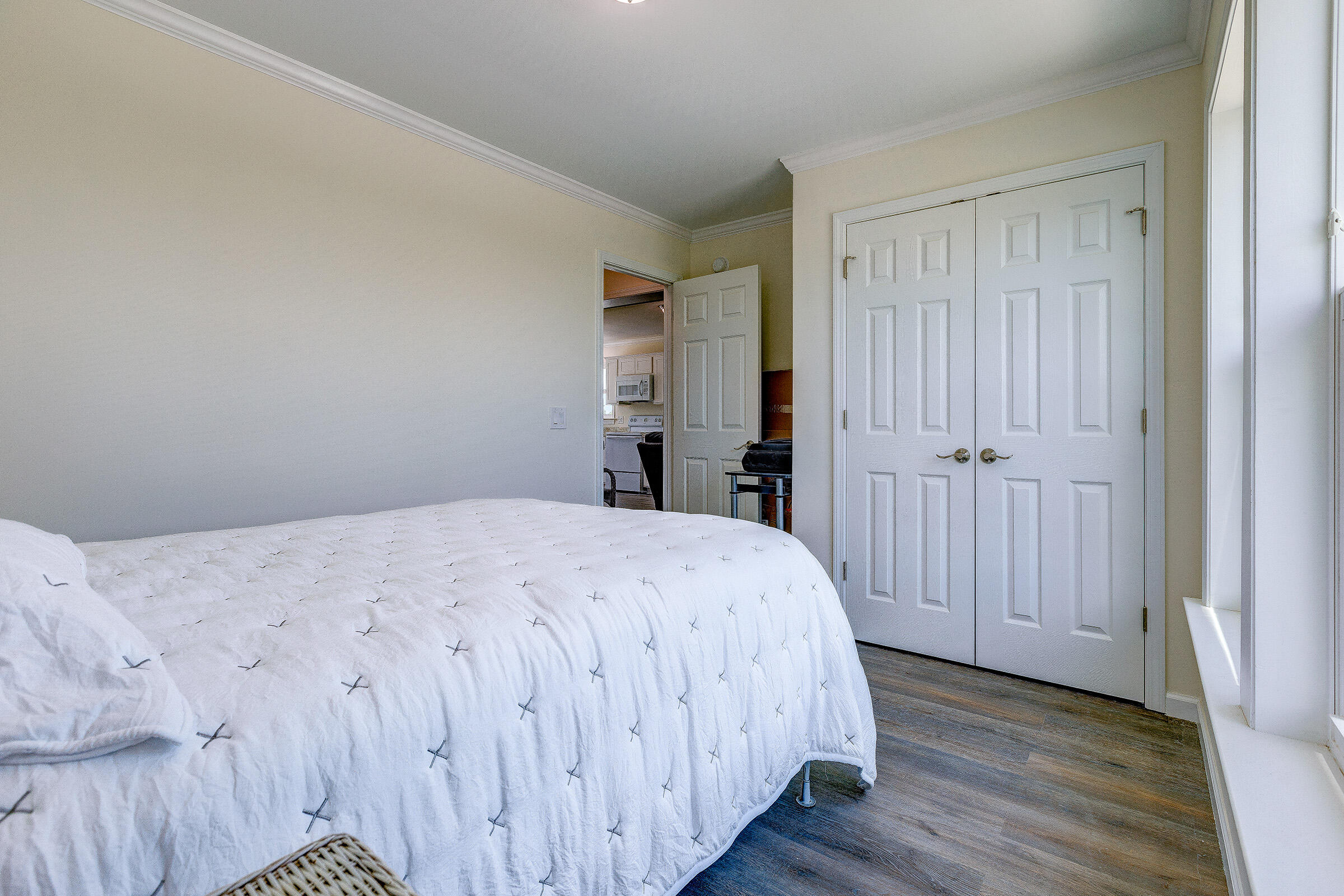 55 Boca Chica Road, Unit 27 Key West, FL 33040 - Photo 7 of 20 a bedroom with a bed and wooden floor