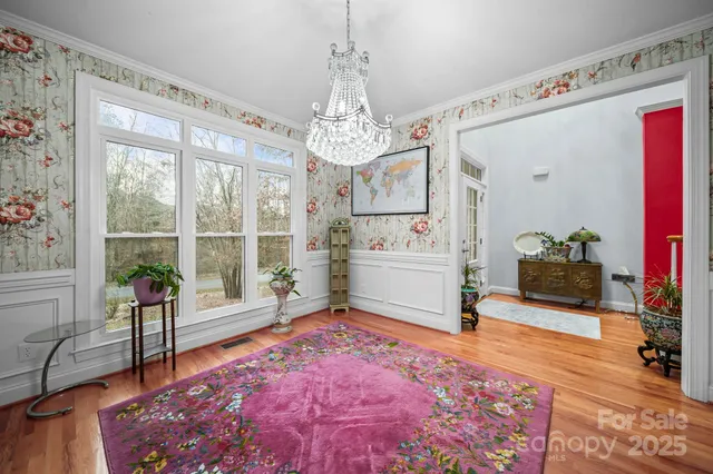 a living room with furniture and a chandelier