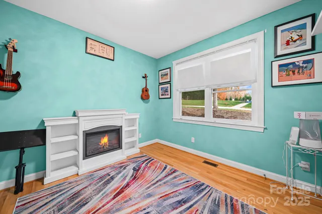 a bedroom with a bed and a wooden floor