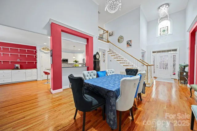 a dining room with furniture and wooden floor