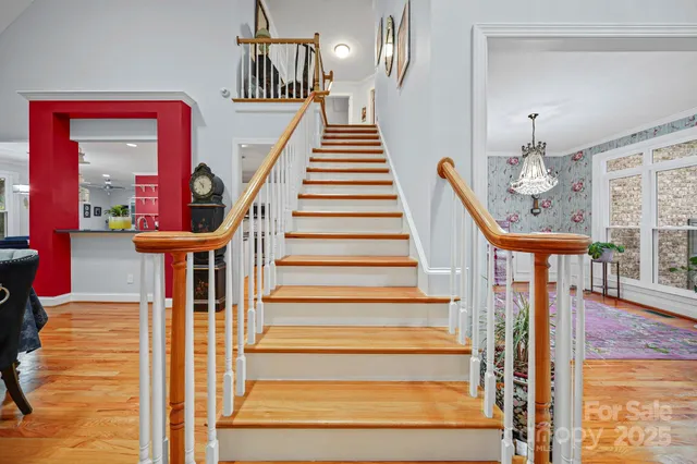 a large kitchen with granite countertop a stove a sink dishwasher and a refrigerator with wooden floor