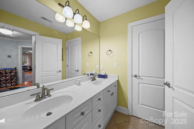 a bathroom with a sink vanity and a mirror