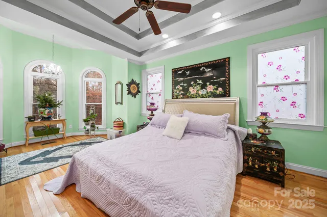 a bedroom with furniture and a large window