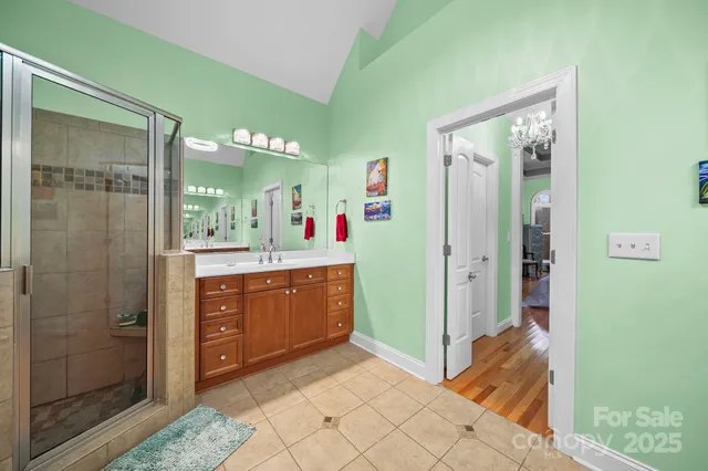 a spacious bathroom with a mirror sink and shower