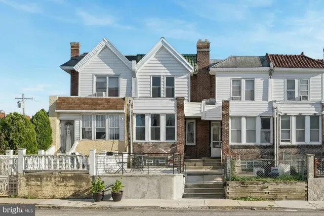 a front view of residential houses with yard