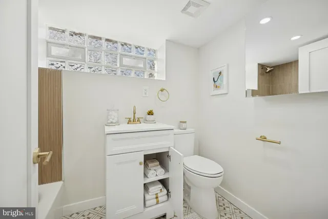 a bathroom with a sink a toilet and vanity
