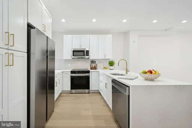 a kitchen with a sink a refrigerator and a stove
