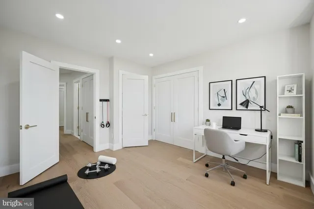 a view of a workspace with furniture and a window