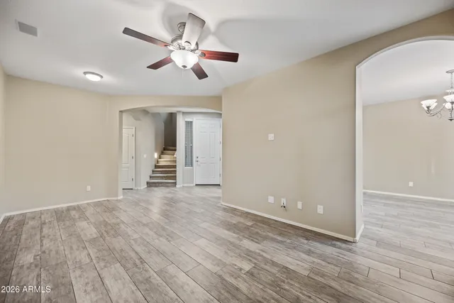 wooden floor in an empty room with a fan