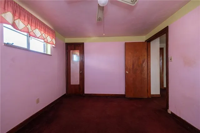a view of empty room with air conditioner and window