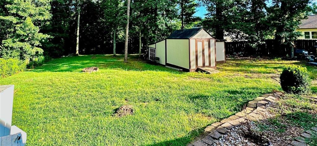 730 Tab Roberts Road Northwest Lawrenceville, GA 30043 - Photo 5 of 6 a view of a white house with a big yard and large trees