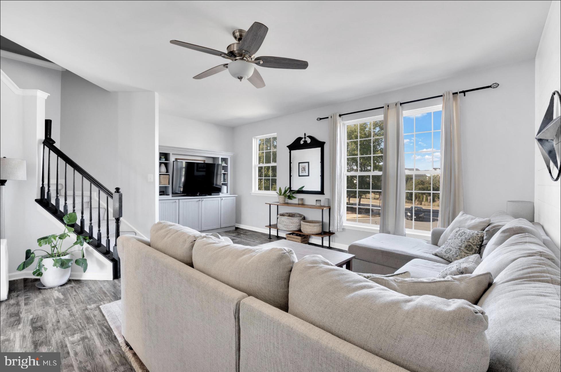 25336 Sweetness Terrace Aldie, VA 20105 - Photo 12 of 33 a living room with furniture and a flat screen tv with wooden floor