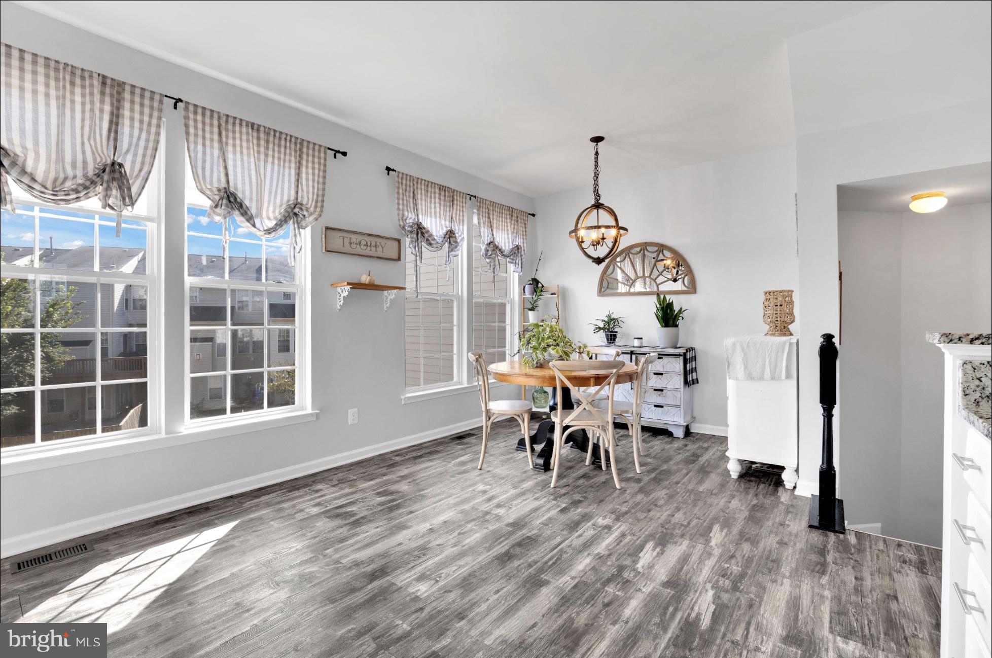 25336 Sweetness Terrace Aldie, VA 20105 - Photo 17 of 33 a view of a dining room with furniture window and wooden floor