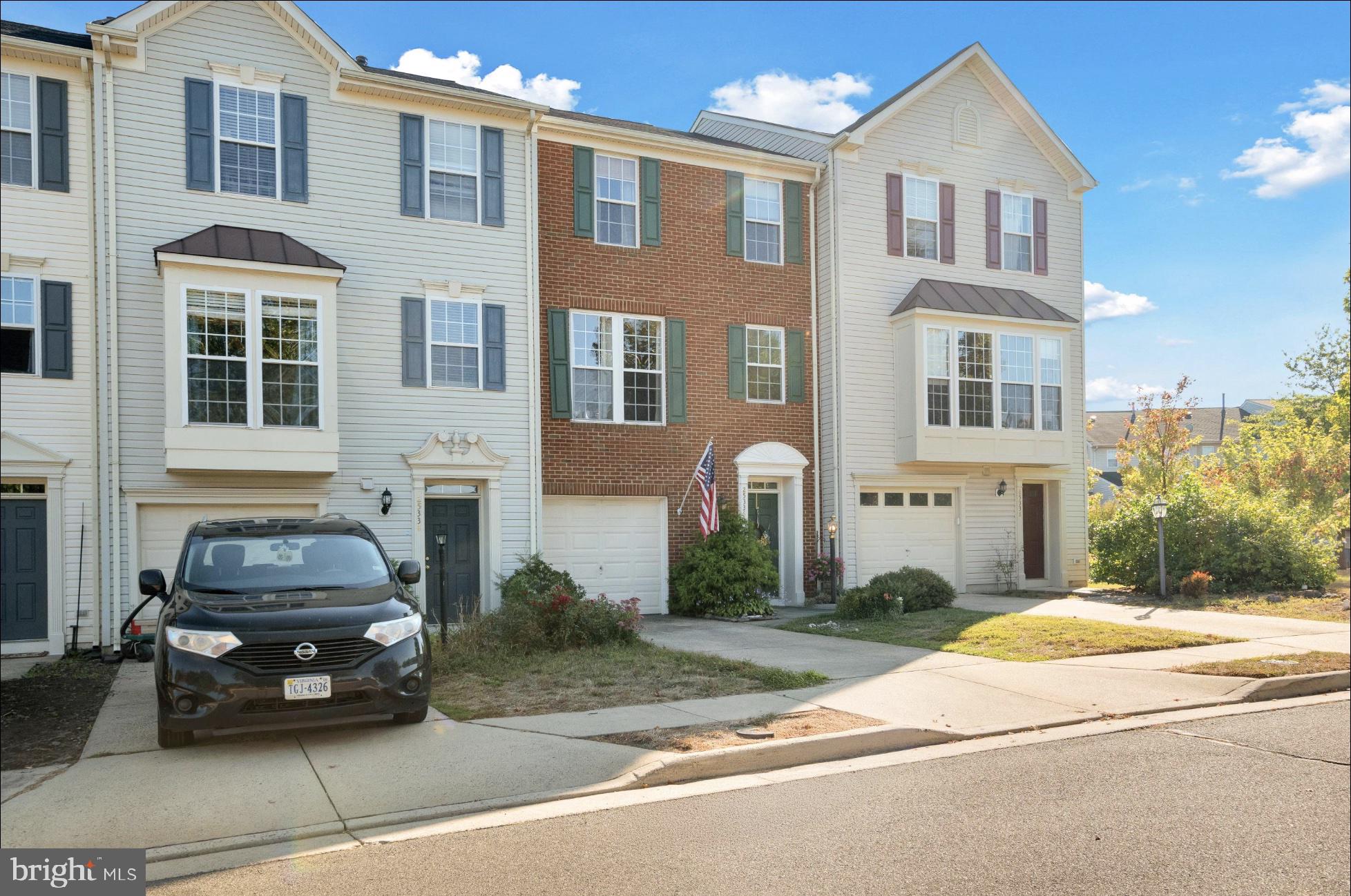 25336 Sweetness Terrace Aldie, VA 20105 - Photo 5 of 33 a car parked in front of a brick house