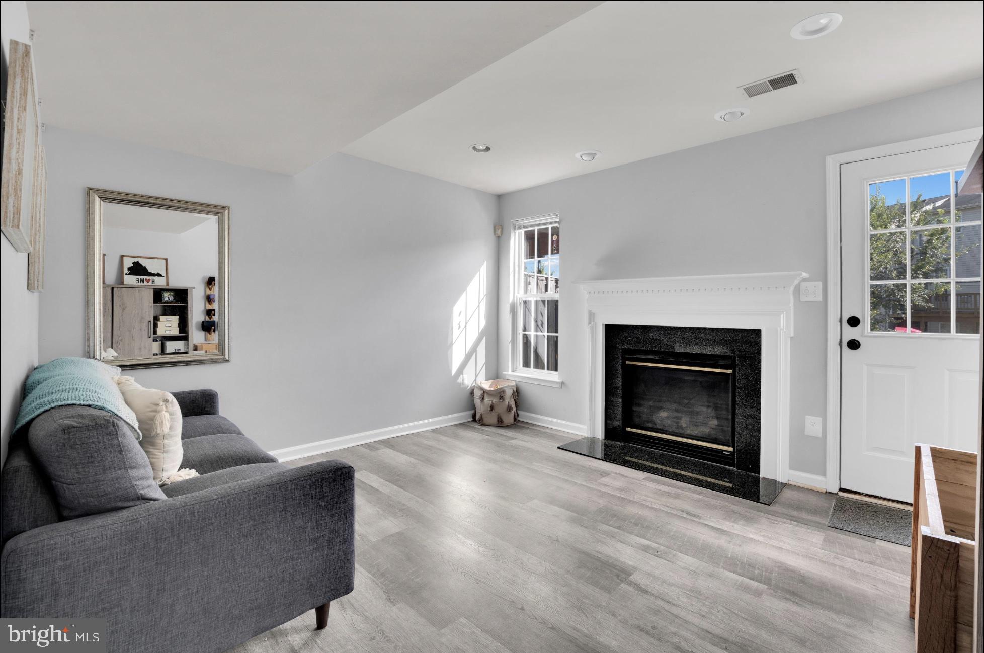25336 Sweetness Terrace Aldie, VA 20105 - Photo 7 of 33 a living room with furniture and a fireplace