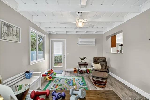 a dining room with stainless steel appliances kitchen island granite countertop a dining table chairs and a oven