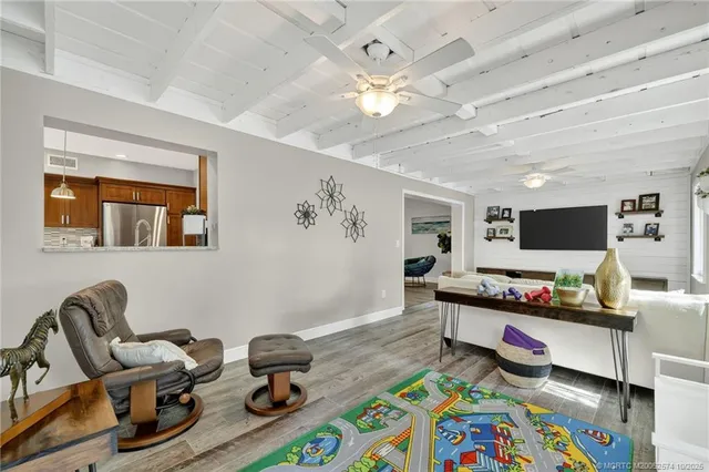 a view of a livingroom with workspace and a window