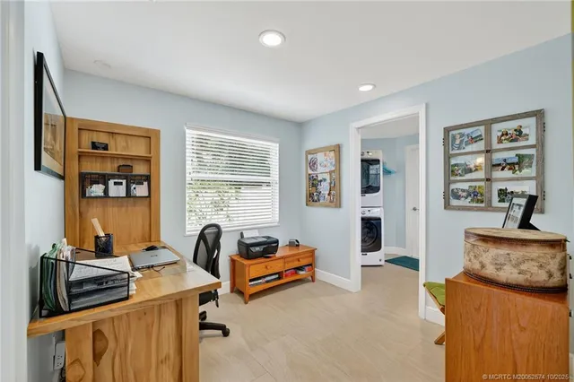 a bedroom with a bed television and a large window