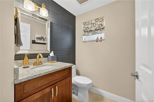 a bathroom with a sink vanity and mirror
