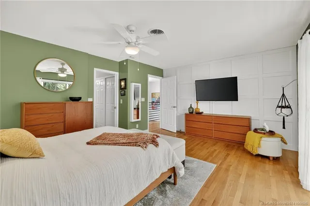 a bedroom with a bed and wooden floor