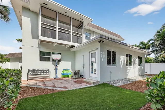 an aerial view of a house with a yard and lake view