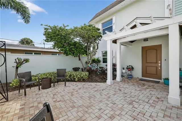 a living room with furniture a wooden floor and a lamp