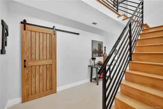 a living room with furniture and a dining table with kitchen view