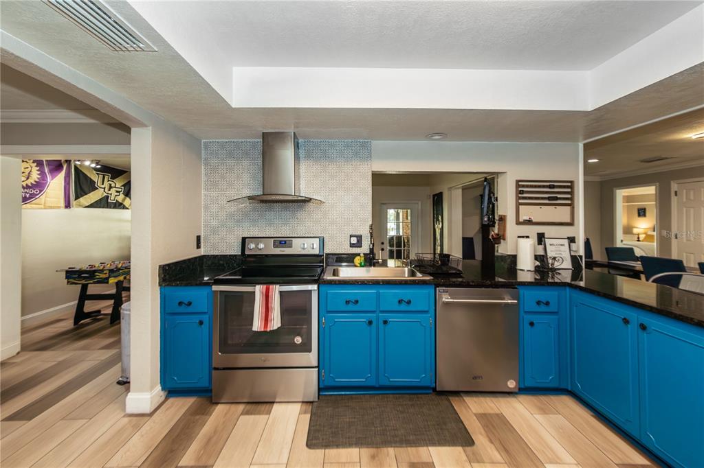 5584 North Dean Road Orlando, FL 32817 - Photo 11 of 39 a kitchen with stainless steel appliances granite countertop a stove and a sink