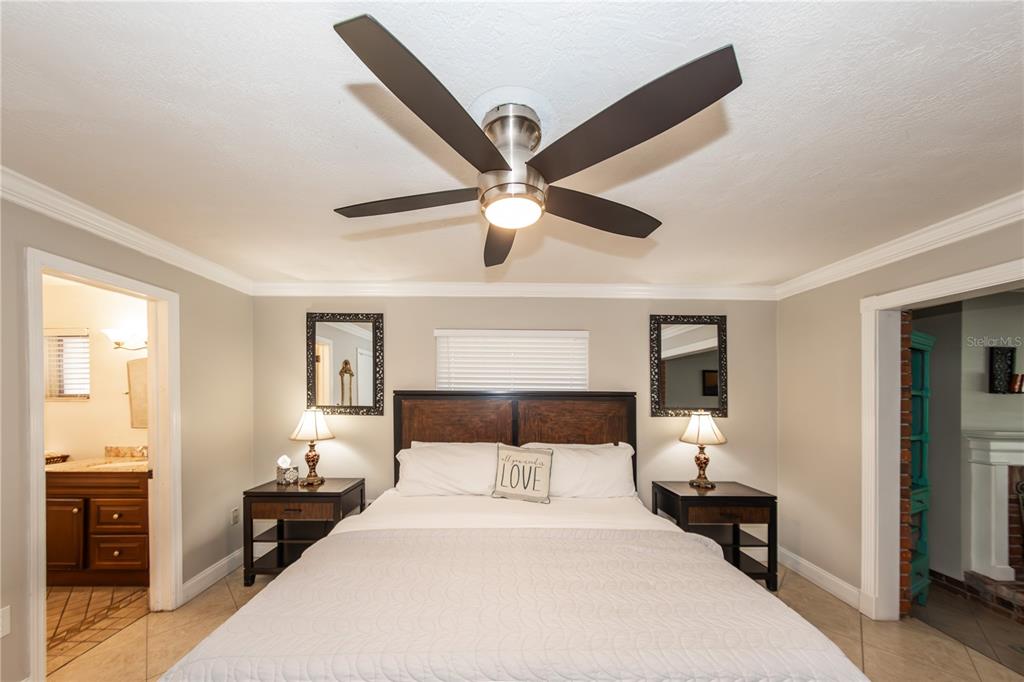 5584 North Dean Road Orlando, FL 32817 - Photo 15 of 39 a bedroom with a bed and wooden floor