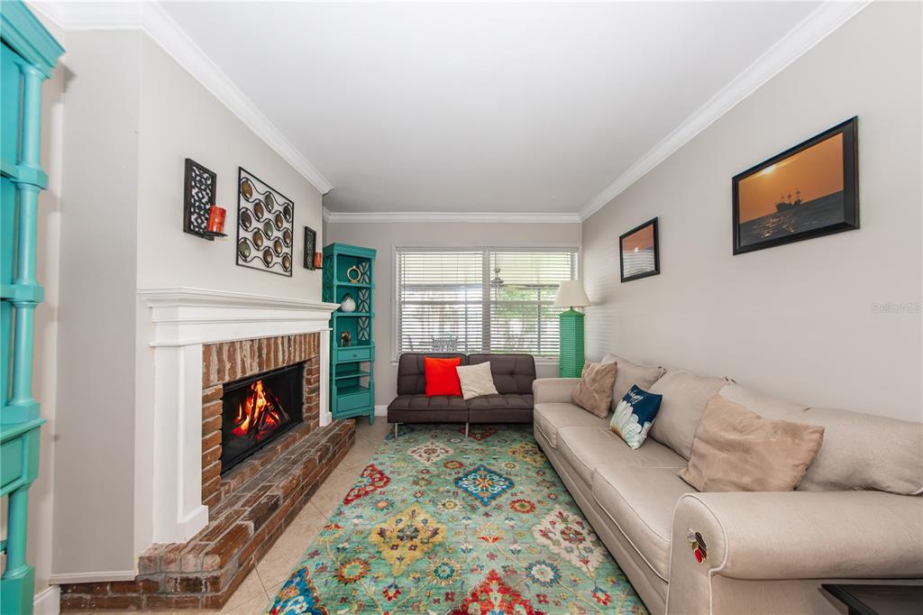 5584 North Dean Road Orlando, FL 32817 - Photo 16 of 39 a living room with furniture fireplace and window