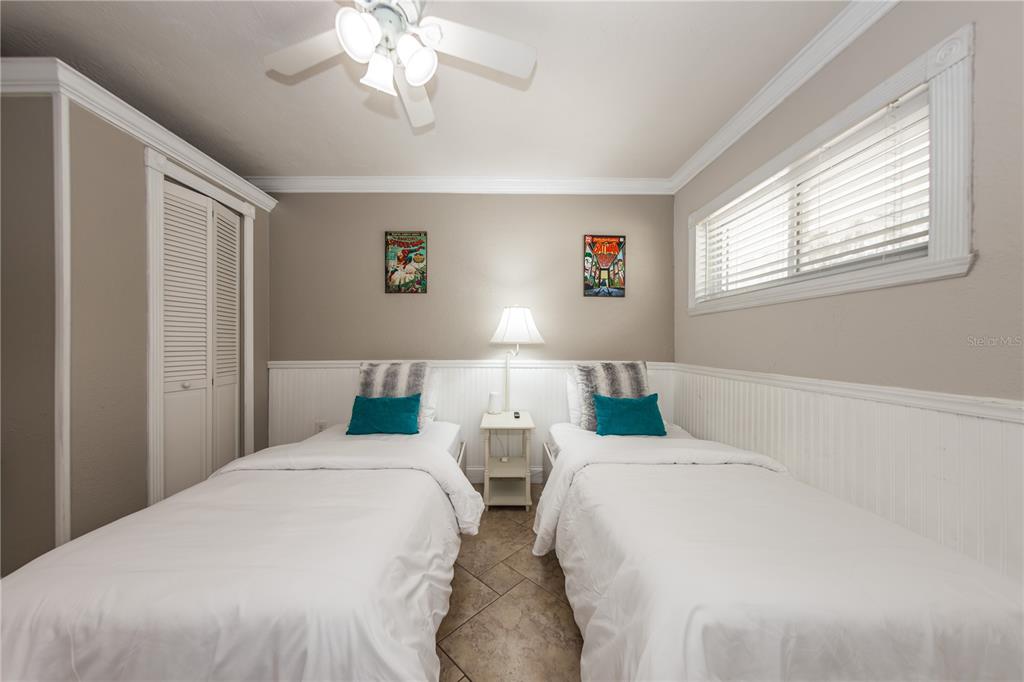 5584 North Dean Road Orlando, FL 32817 - Photo 17 of 39 a bedroom with two beds and a window