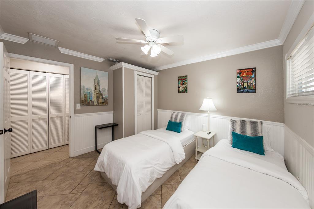 5584 North Dean Road Orlando, FL 32817 - Photo 18 of 39 a bedroom with a large bed and a chandelier