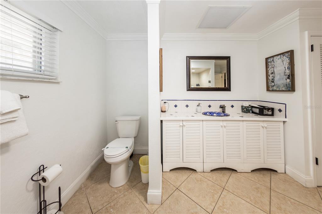 5584 North Dean Road Orlando, FL 32817 - Photo 21 of 39 a white toilet sitting next to a bathroom sink