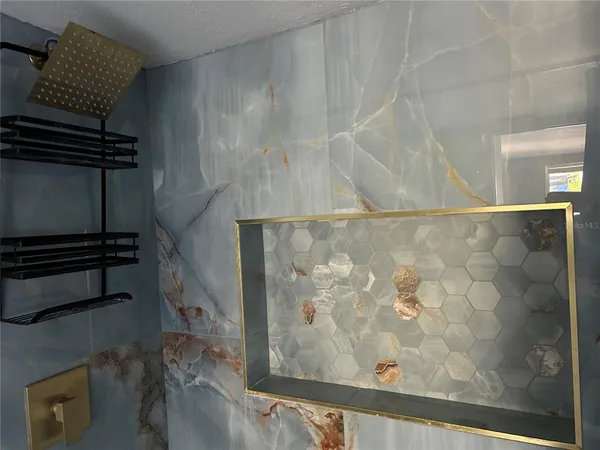 an empty room with wooden floor and closet area